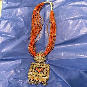 Gorgeous burnt orange beaded multi strand with stunning orange & silver pendant.